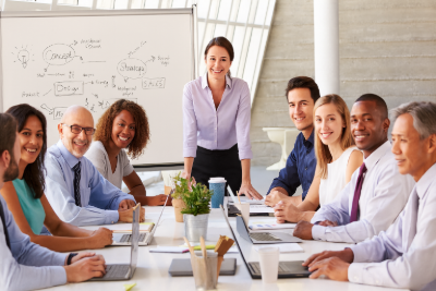 Professionals collaborating in a team meeting while planning a career transition into project management